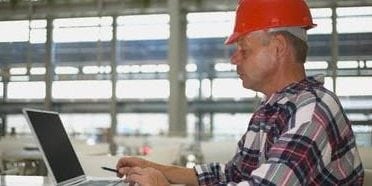 construction worker on a laptop