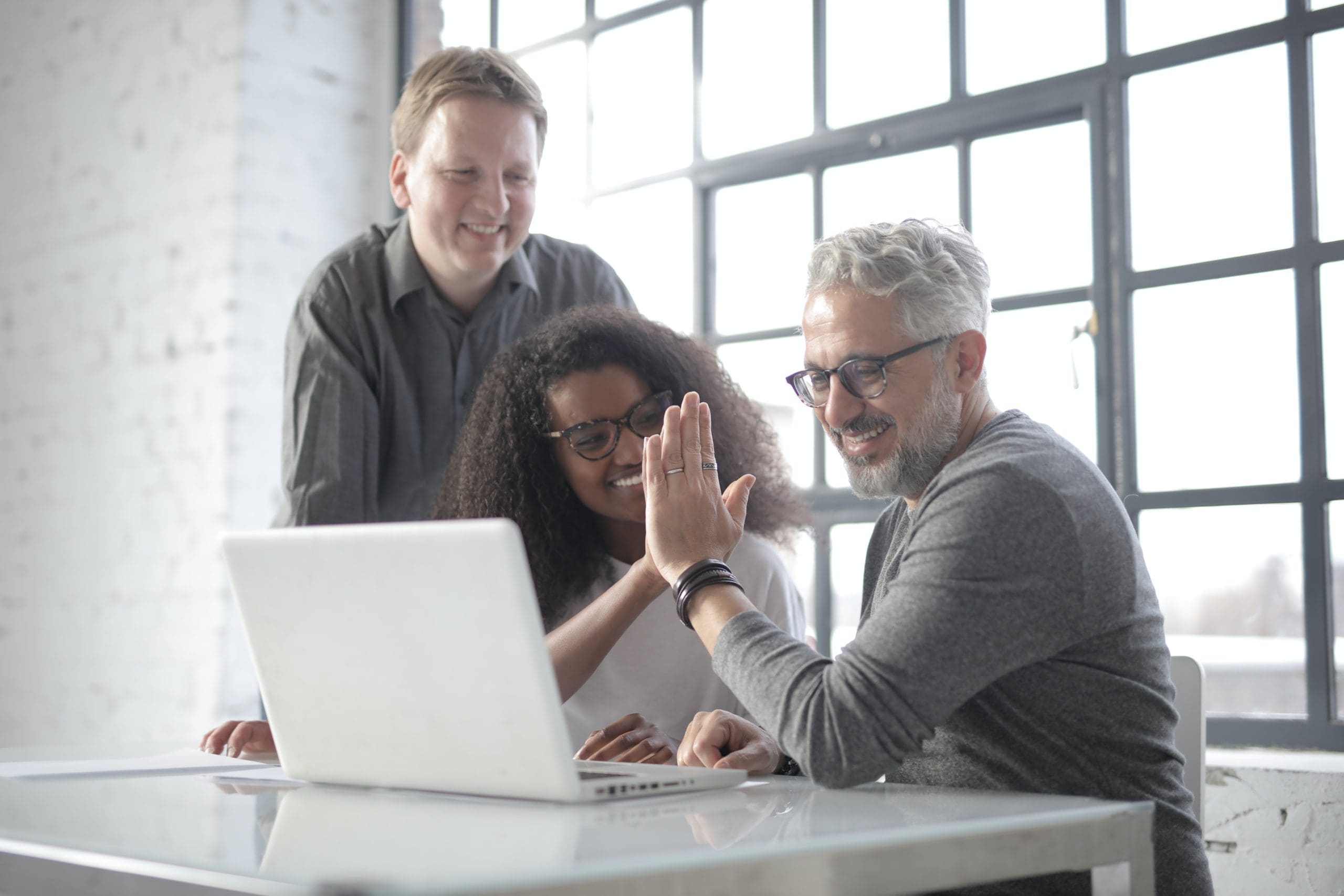 Team members celebrating after setting up invoice workflows in QuickBooks Online Advanced