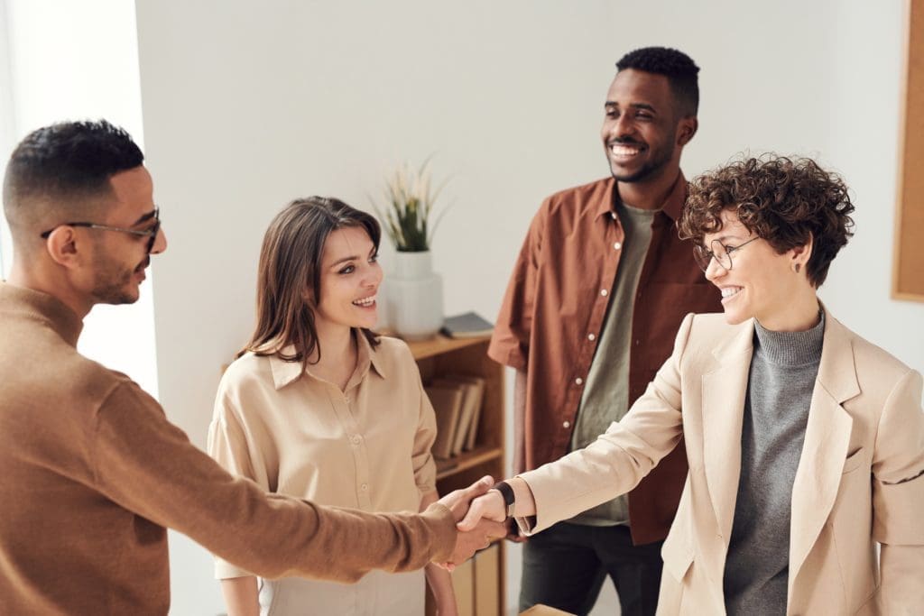 Business owner shaking hands with customers