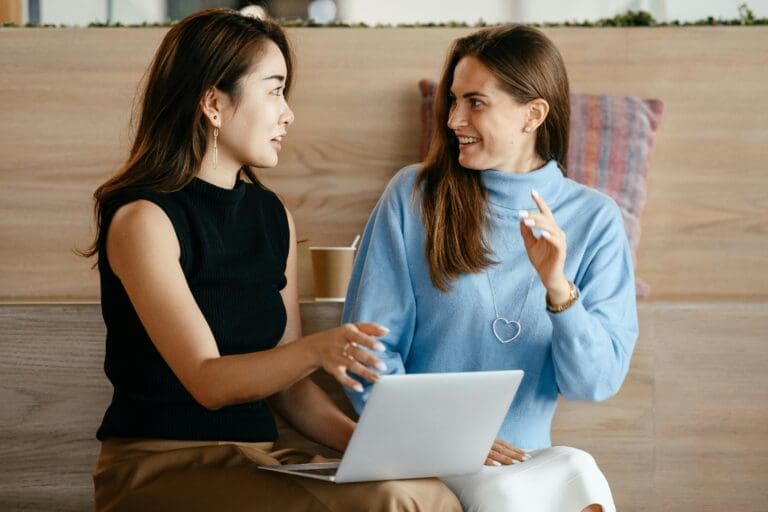 Two businesswomen discussing about QuickBooks Online Advanced for Salesforce CRM