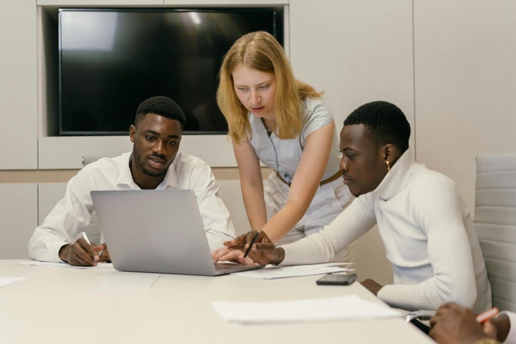 Team members discussing which QuickBooks Online version to choose