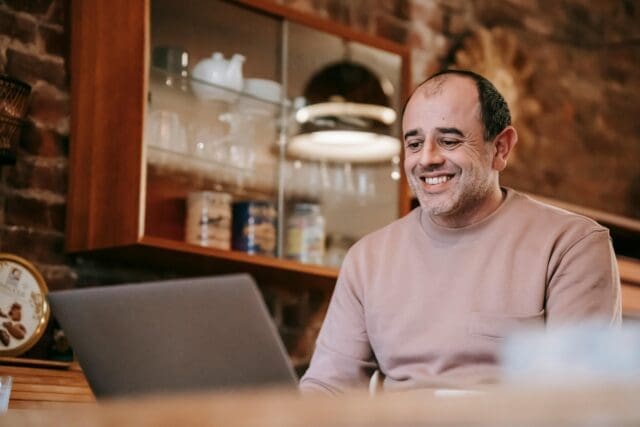 Businessman delightedly looking at his laptop